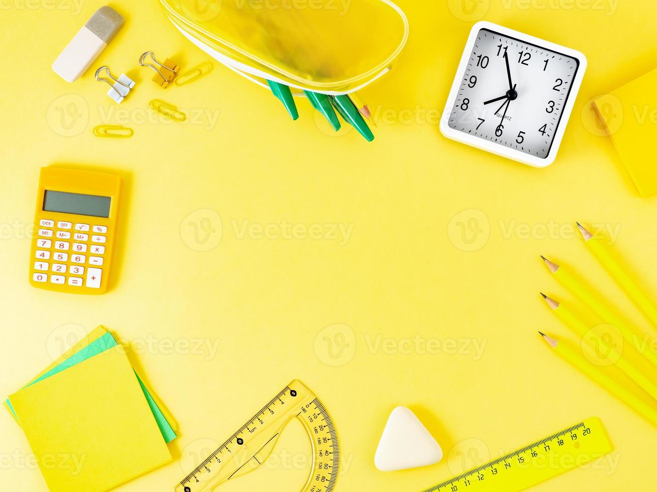 Top view of modern bright yellow office desktop with school supplies on table, empty space for text. Back to school concept. photo