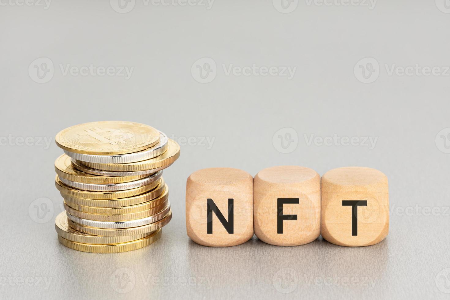 NFT concept. Stacked crypto coins and wooden blocks with text. Copy space photo