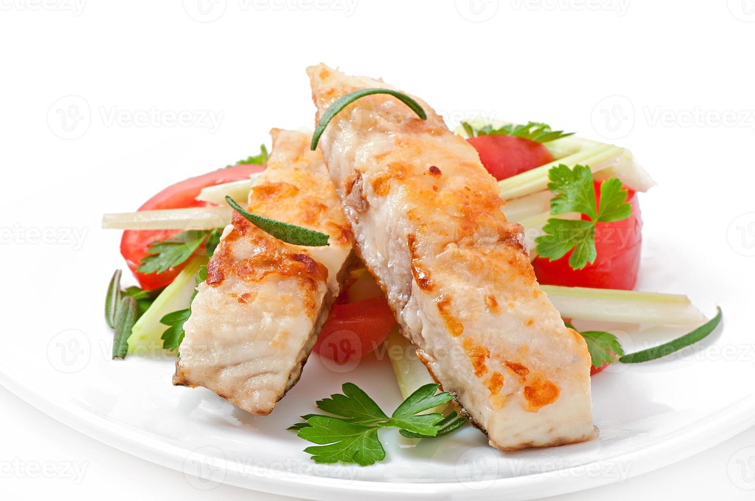 Fried filet fish and fresh vegetable salad photo