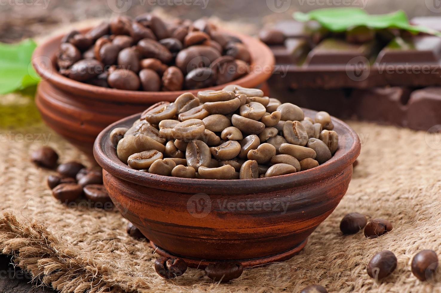 Green and brown coffee beans in bowls photo