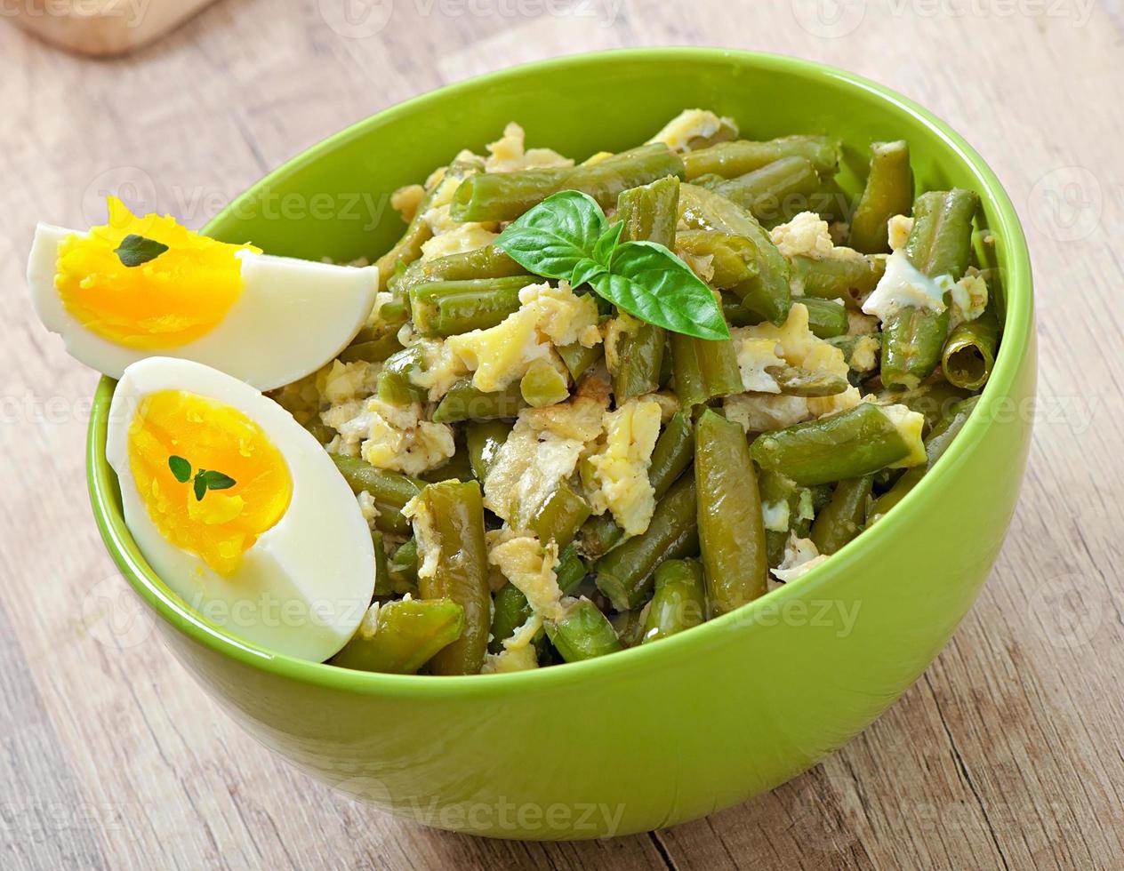 String beans with eggs in bowl. photo