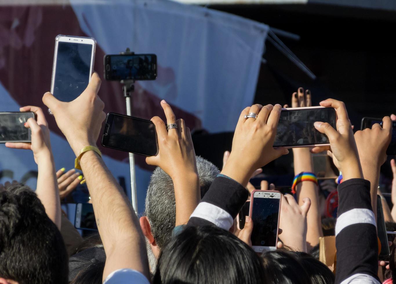 Buenos Aires, Argentina. 2019. Many hands taking cell phone photos