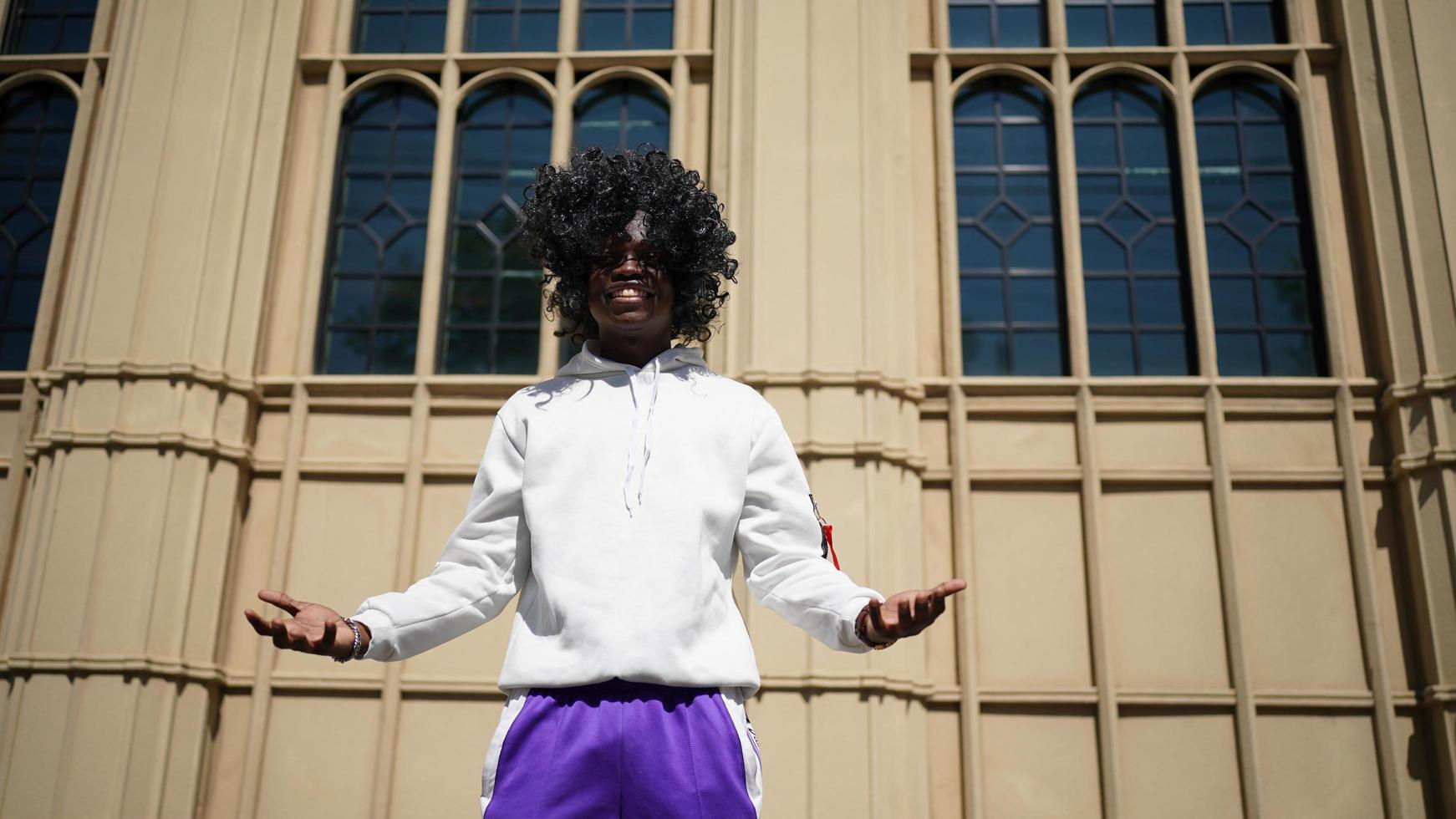 Afro American man having fun walking in city center - Happy young guy enjoying time a sunset outdoor - Millennial generation lifestyle and positive people attitude concept photo