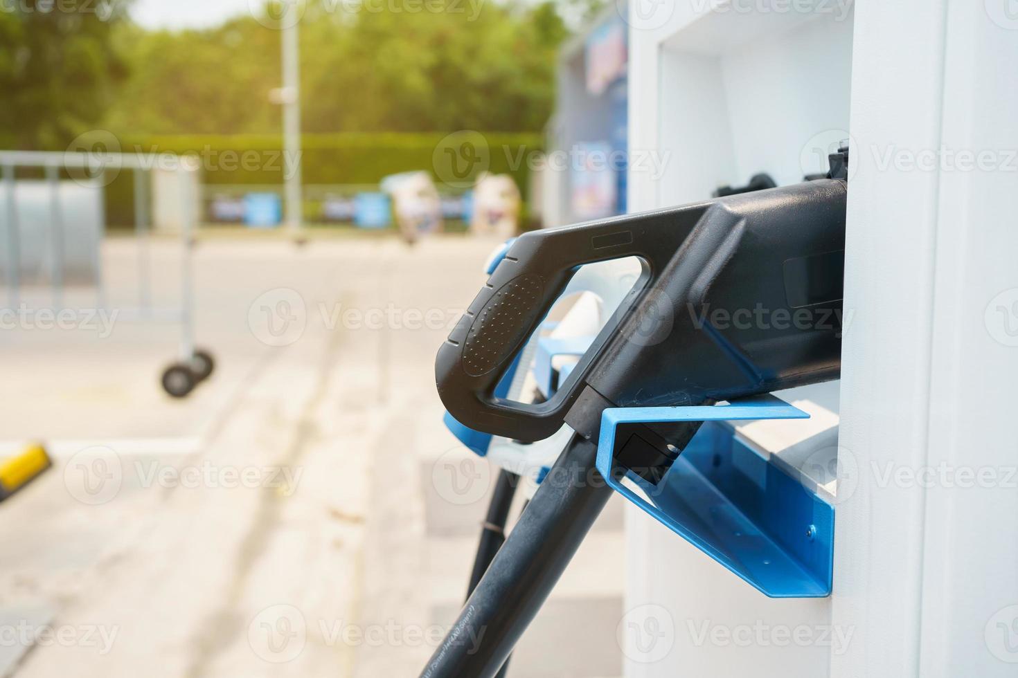 Modern electric vehicle charging connector plugs at ev charging station. DC or direct current and AC or alternating current charging connectors for EV car. photo