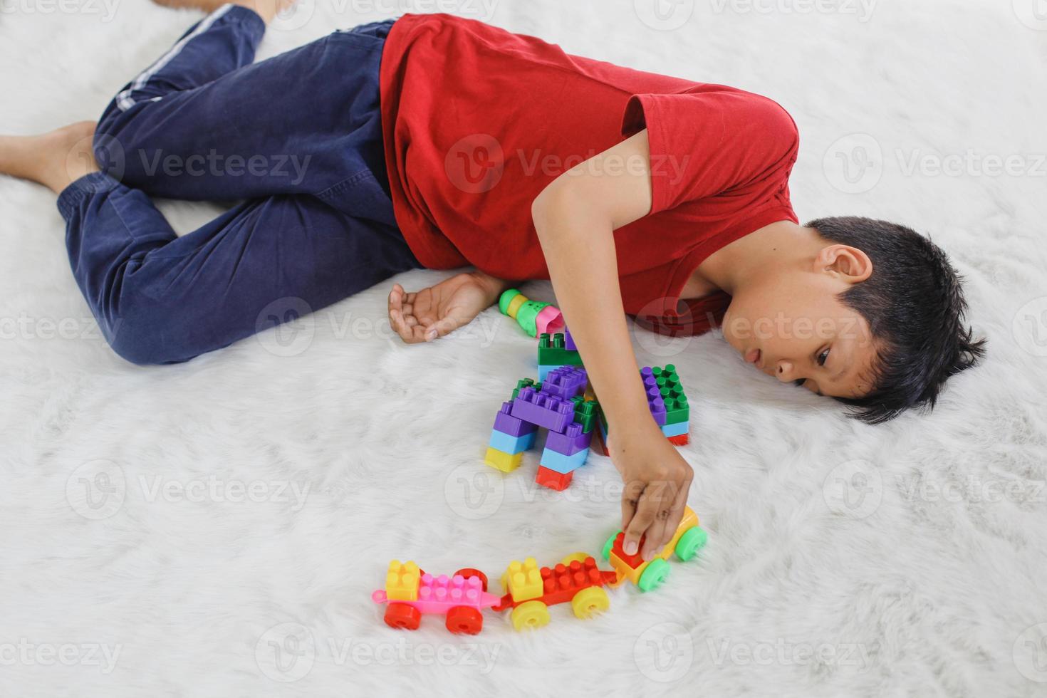 Sad and bored autistic child for being alone playing with toys. Childhood traumatic experience, psychology, psychological, asperger syndrome, asperger's disorder, autistic, autism. photo