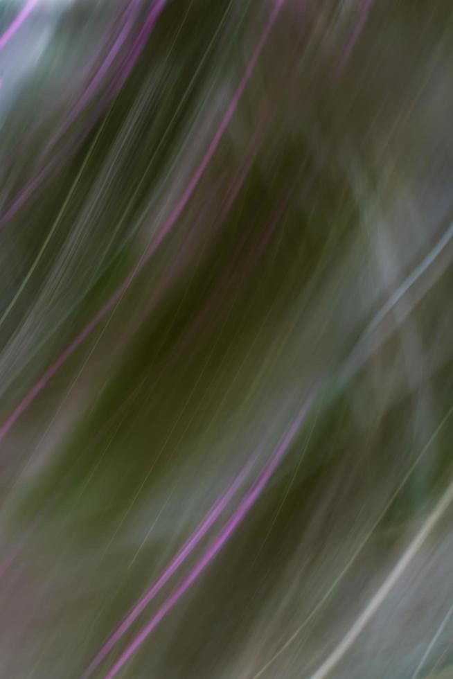 Abstract purple green hazy background. Light blur. Oblique lines and waves. Backdrop. photo