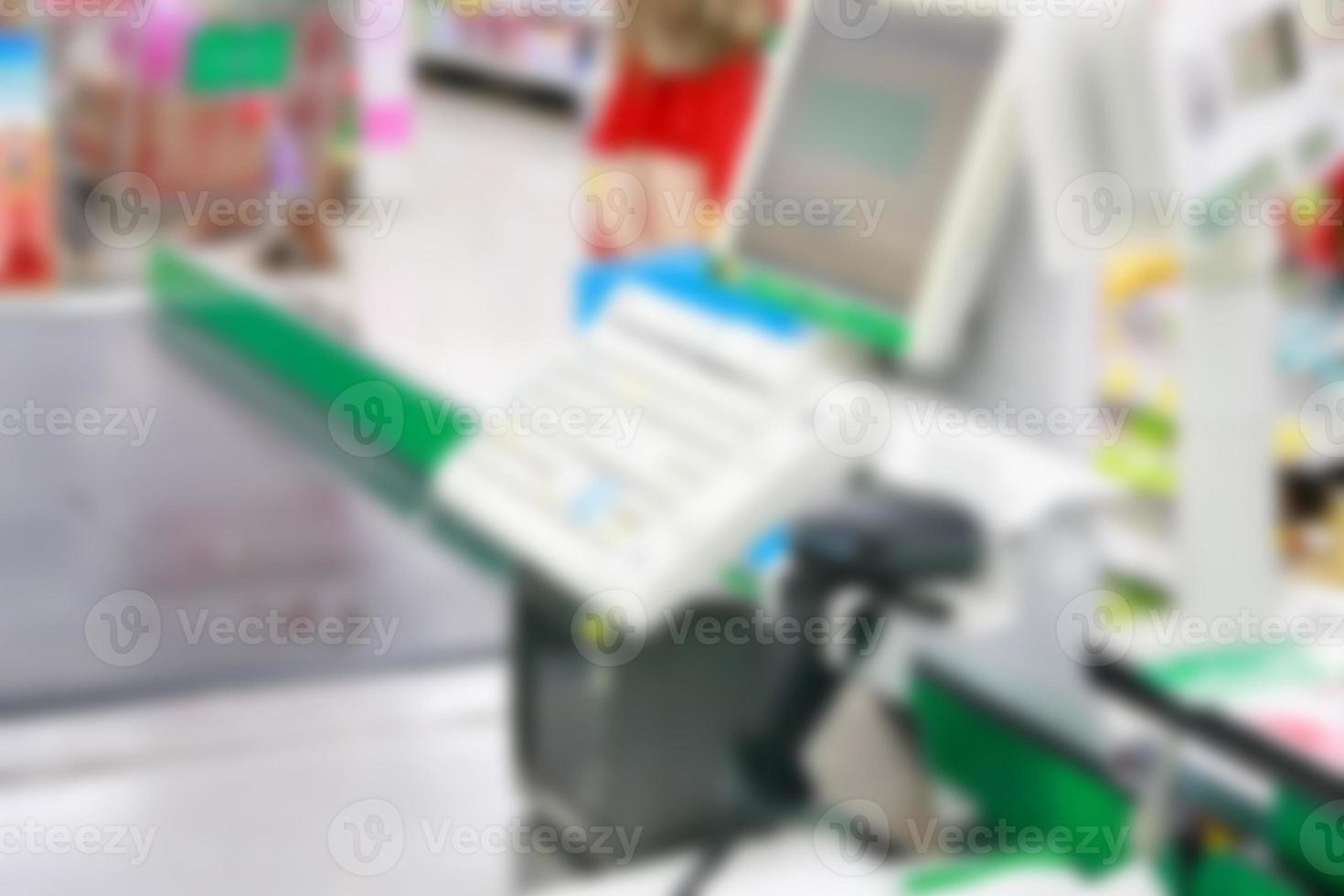 Empty cash desk with payment terminal blurred background photo