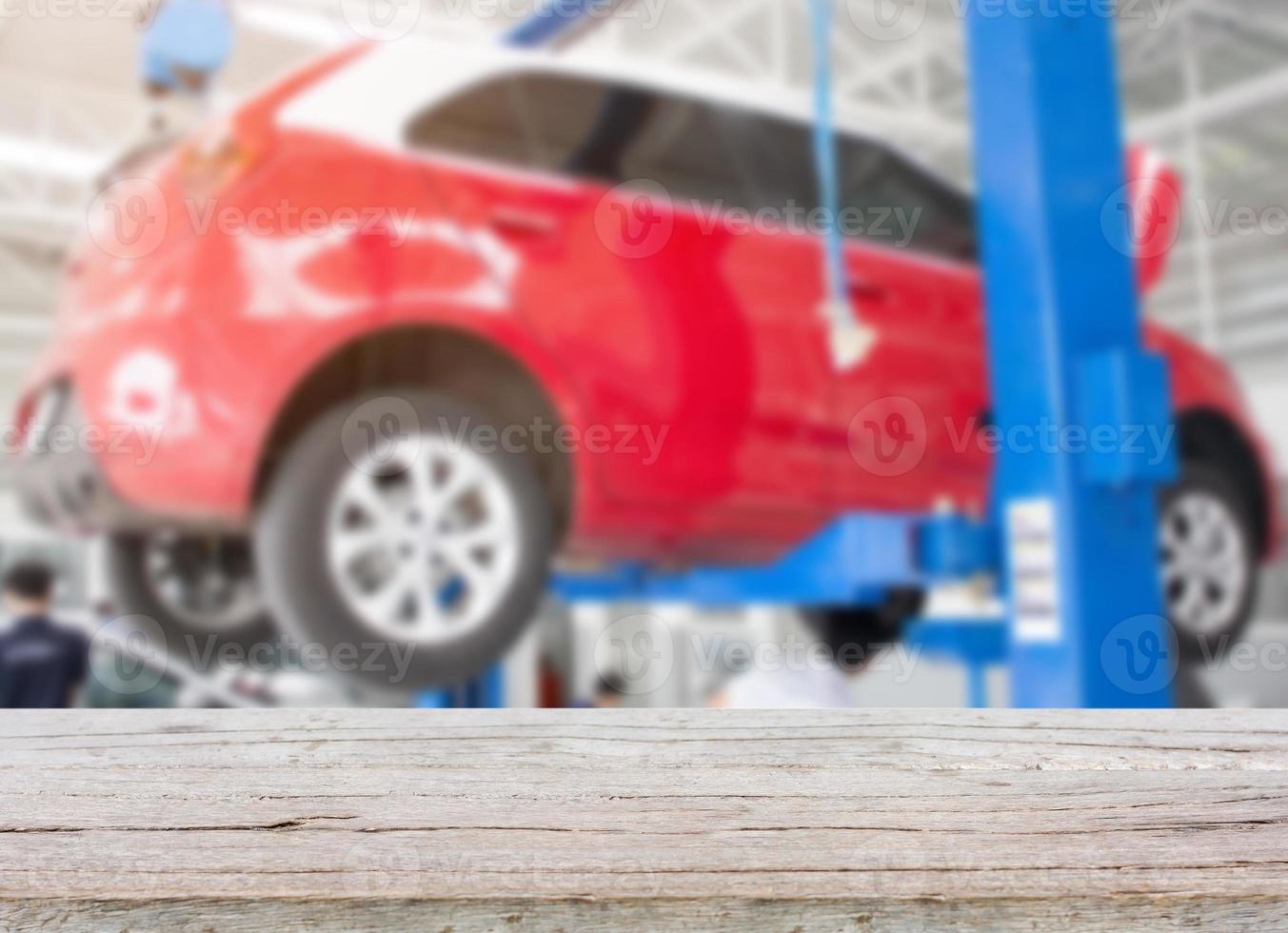 Wood table top with blur car service centre background photo