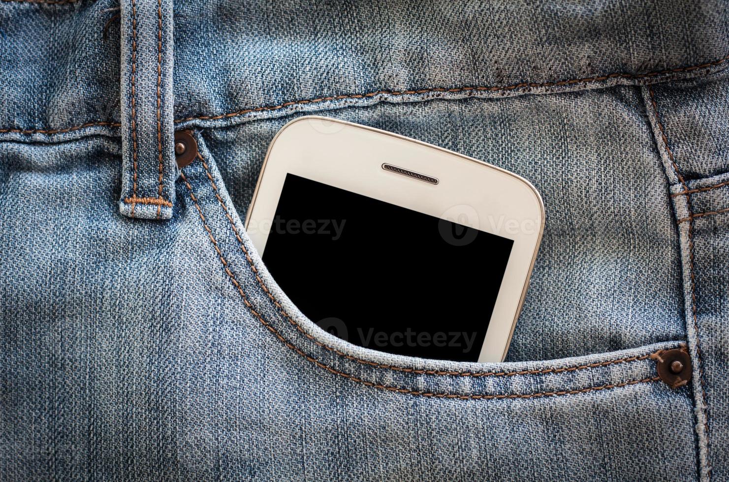mobile phone in jeans pocket with black screen photo
