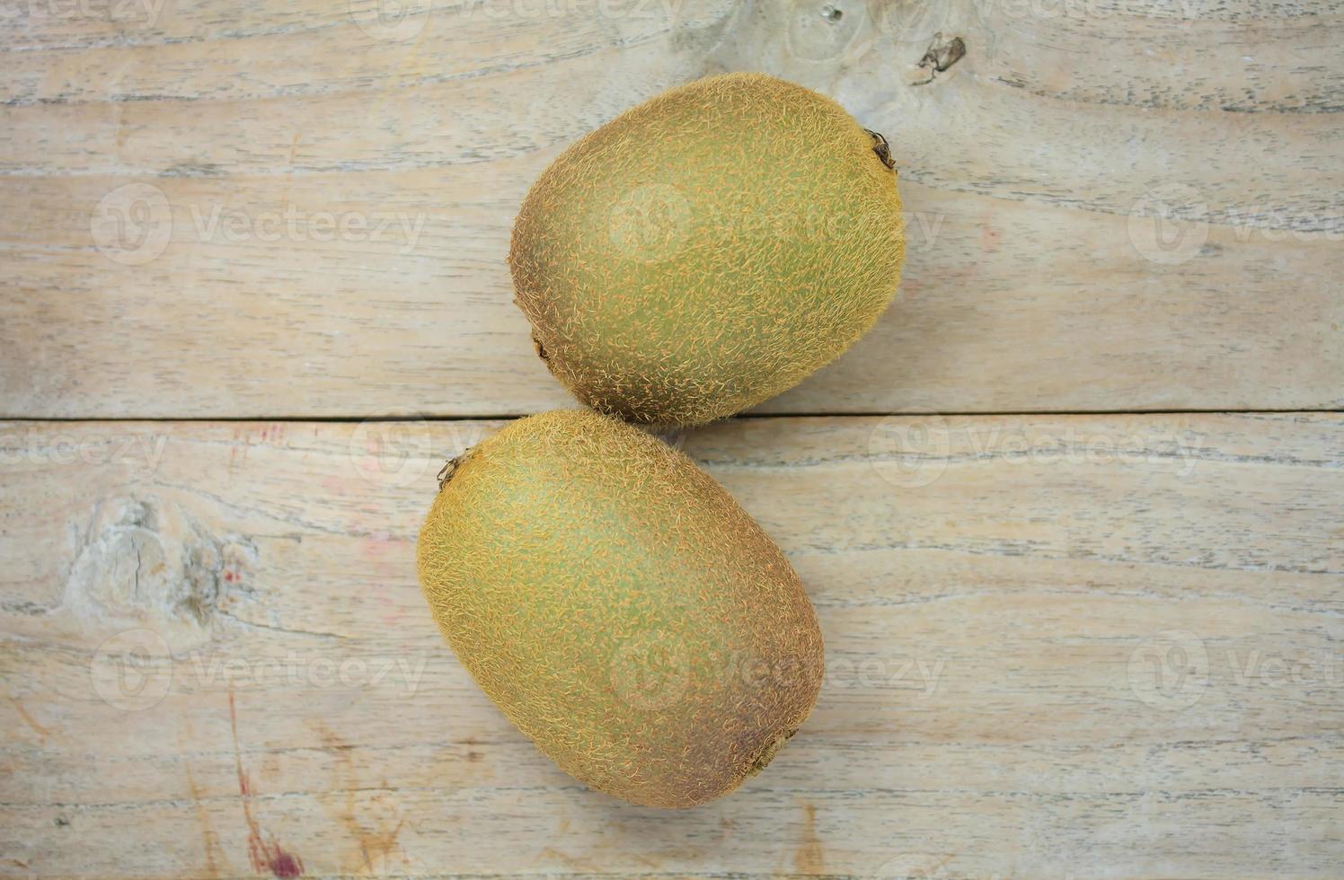 Kiwi fruit on wooden background photo