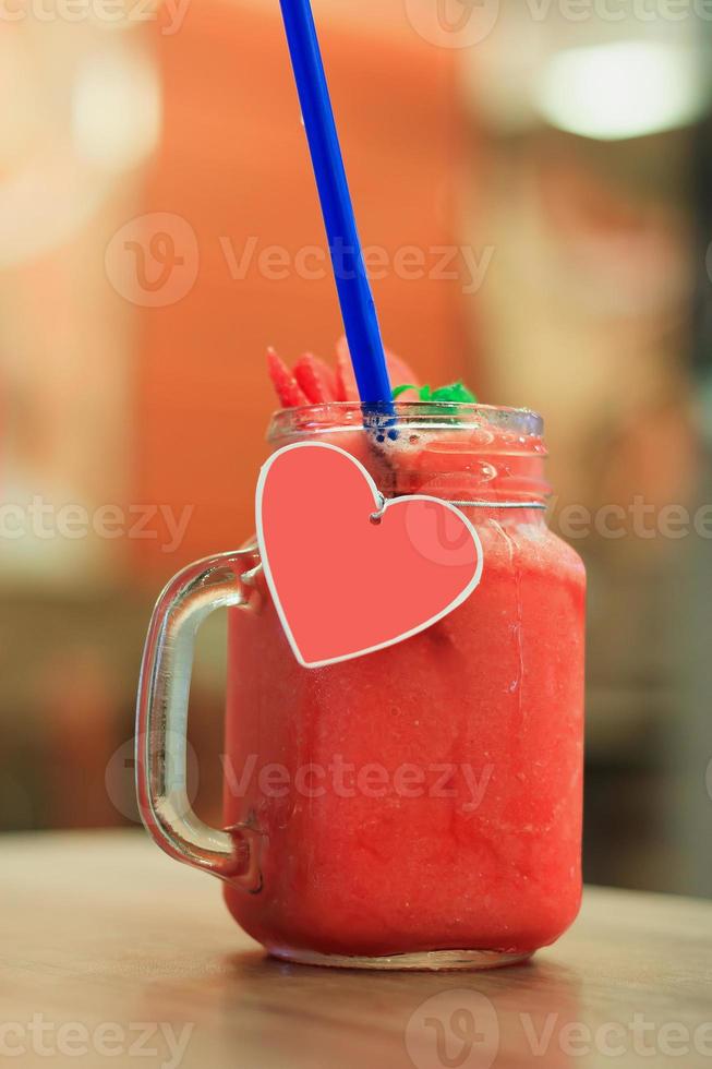 Strawberry smoothie with fresh berries on wood table photo