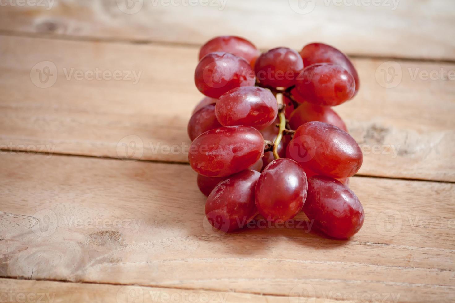 Grapes on a wooden table photo