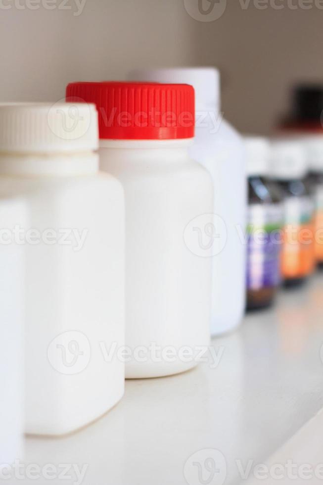 bottles on pharmacy store shelf photo