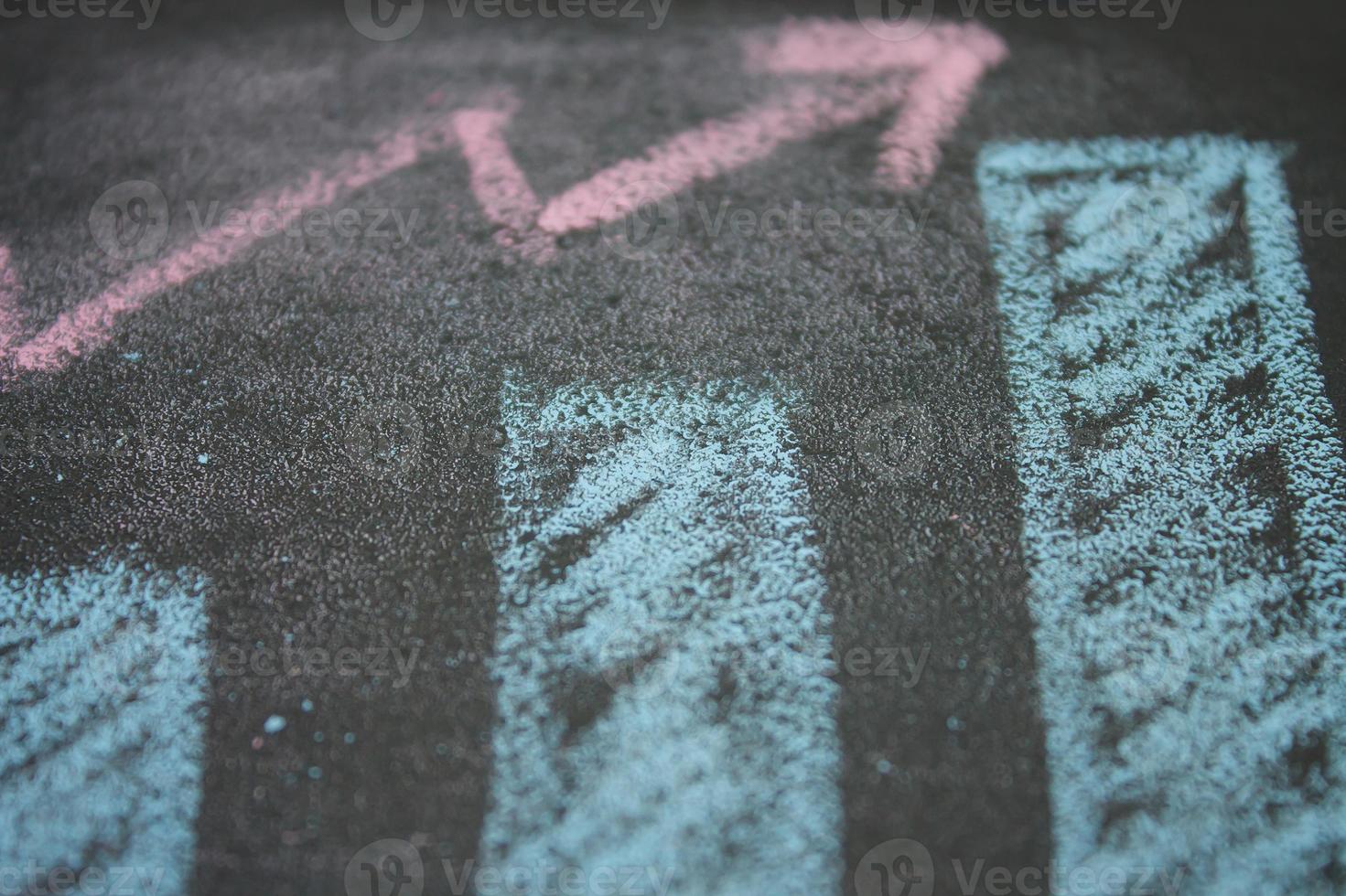 close up of chalkboard with growth business graph chart photo