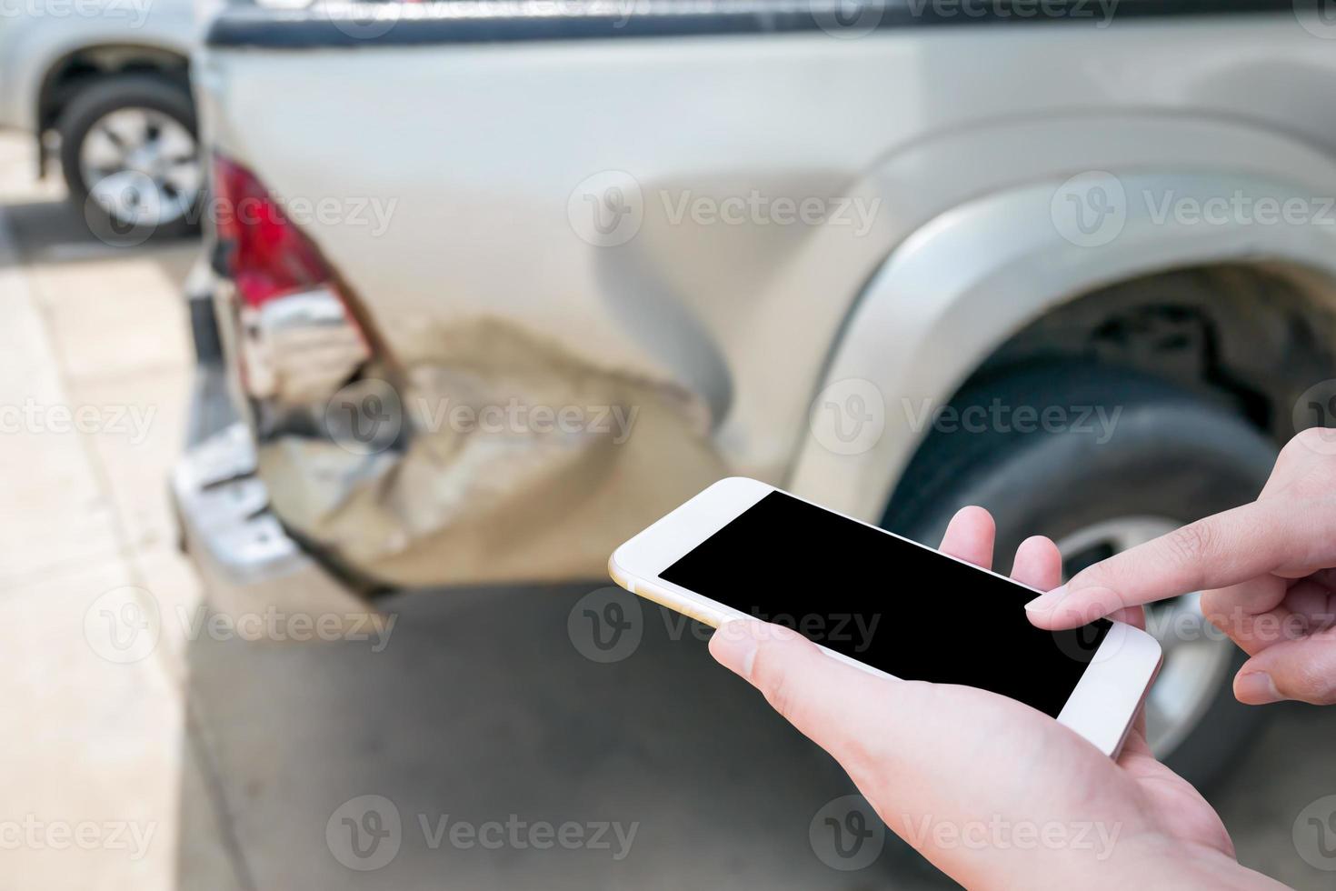 Female using mobile phone after car accident photo