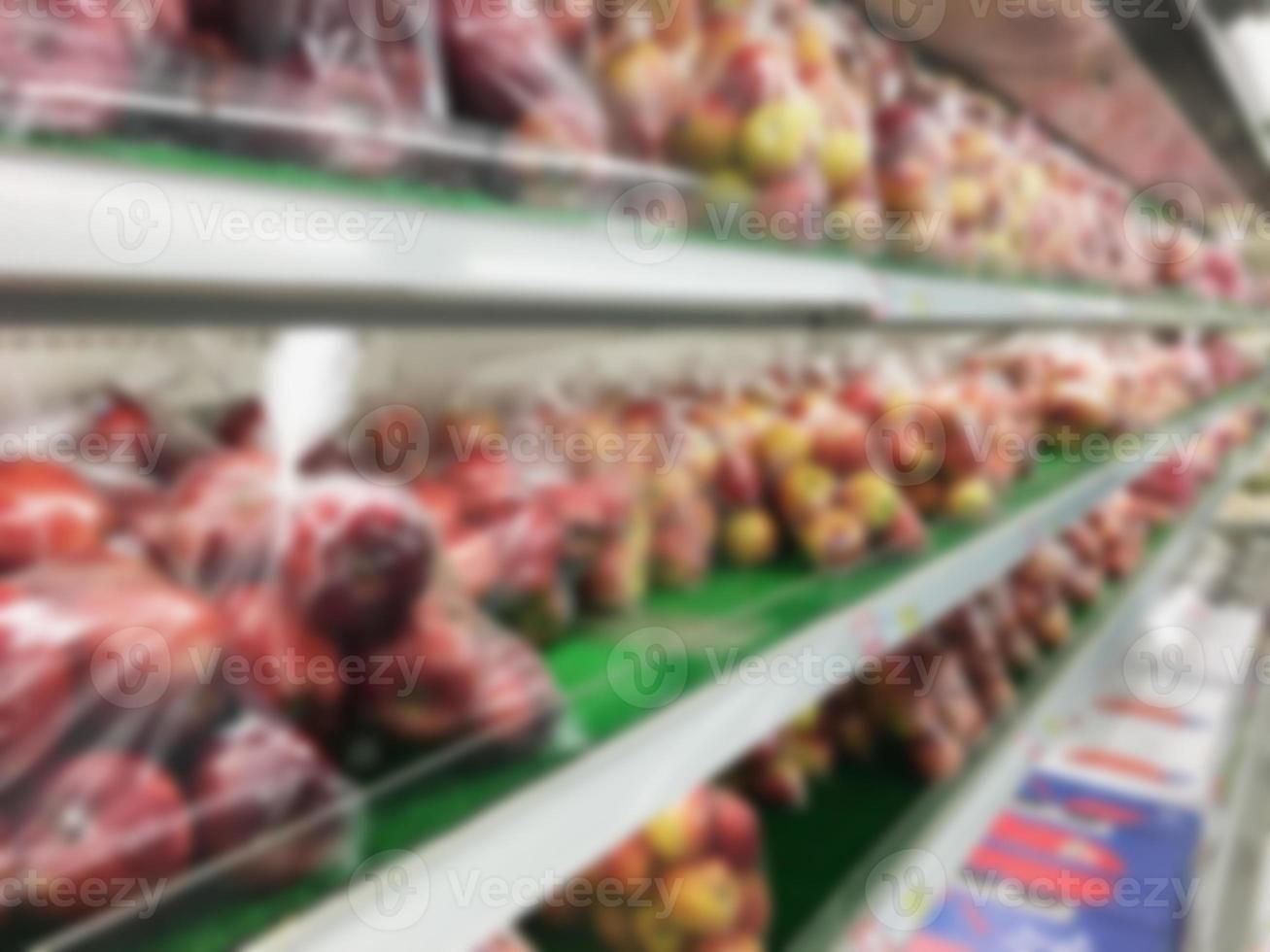 Shelf with fruits in supermarket blurred background photo