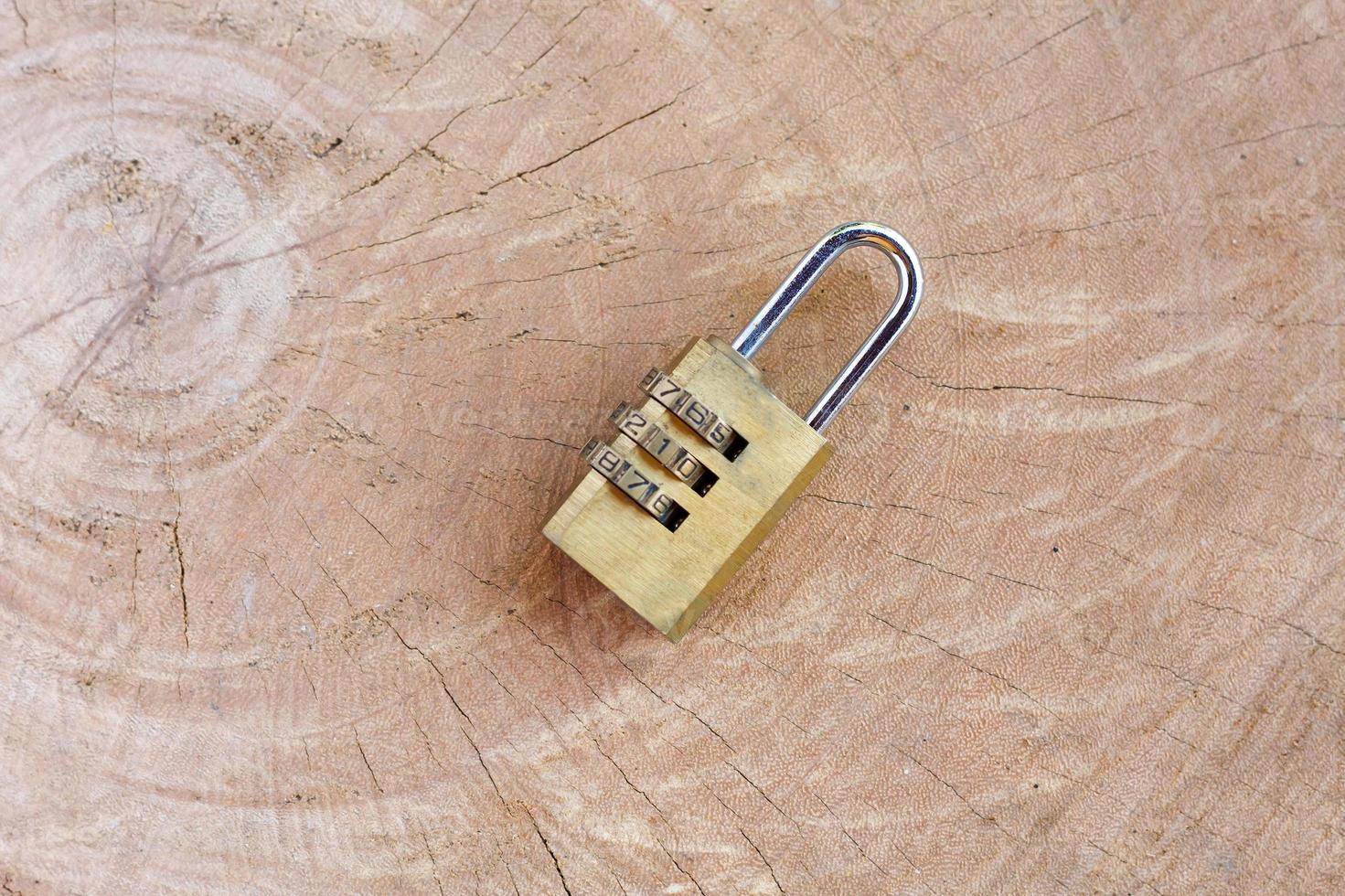 Close up pad lock on wooden background photo