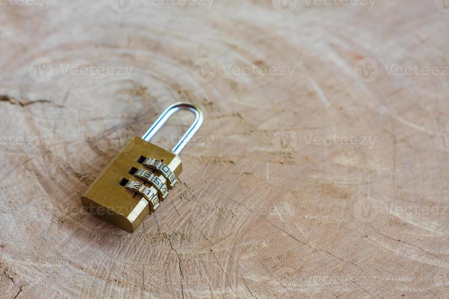 Close up pad lock on wooden background photo
