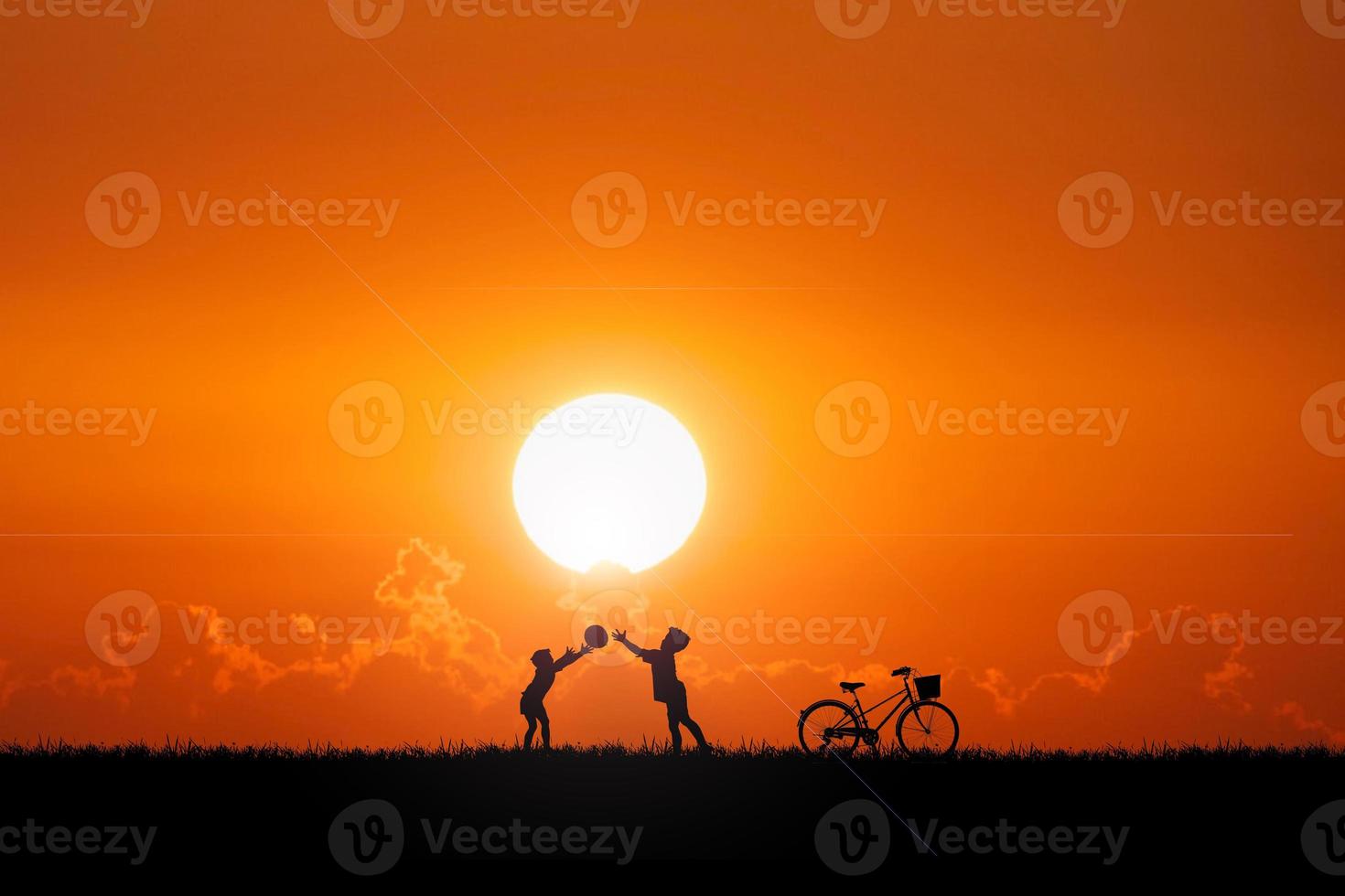 Two children are throwing balls in the meadow happily. Children's happiness concept photo