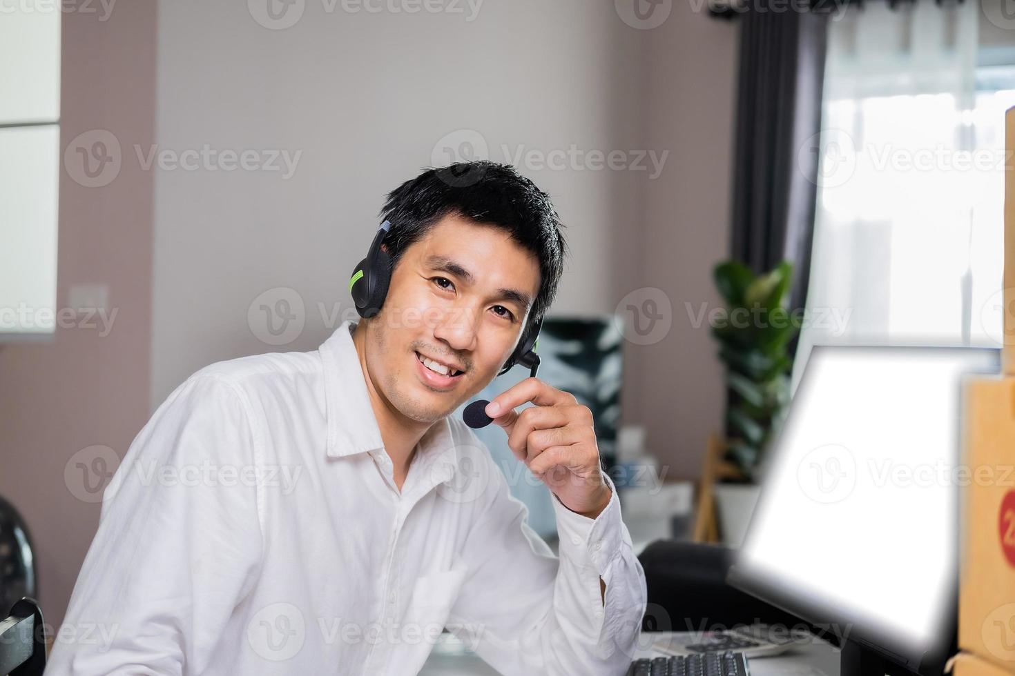 Asian male hand writing order product list on note for online customer in warehouse home office ordering products from online to business cargo supply market service delivery form home office. photo