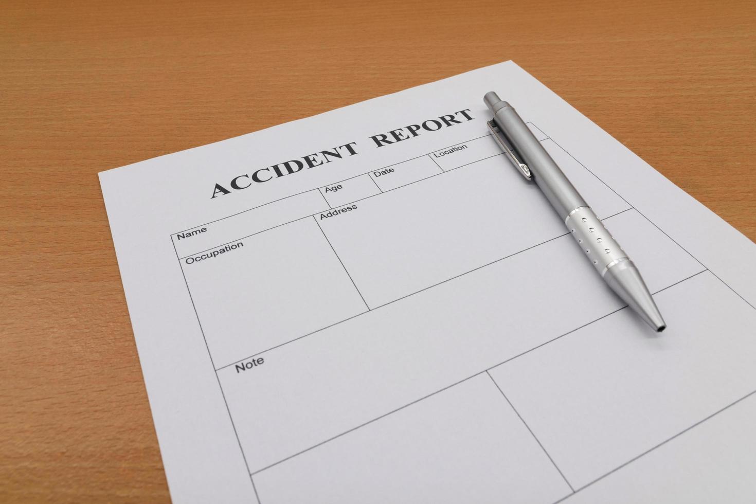 Accident report form with pen on table photo