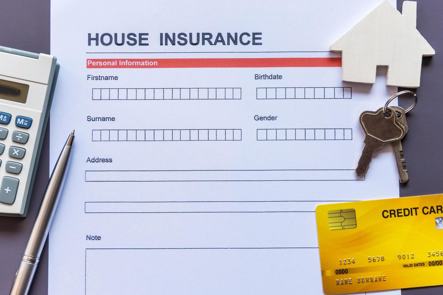 House insurance form with model and policy document photo