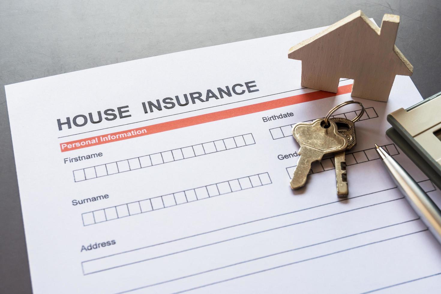 House insurance form with model and policy document photo