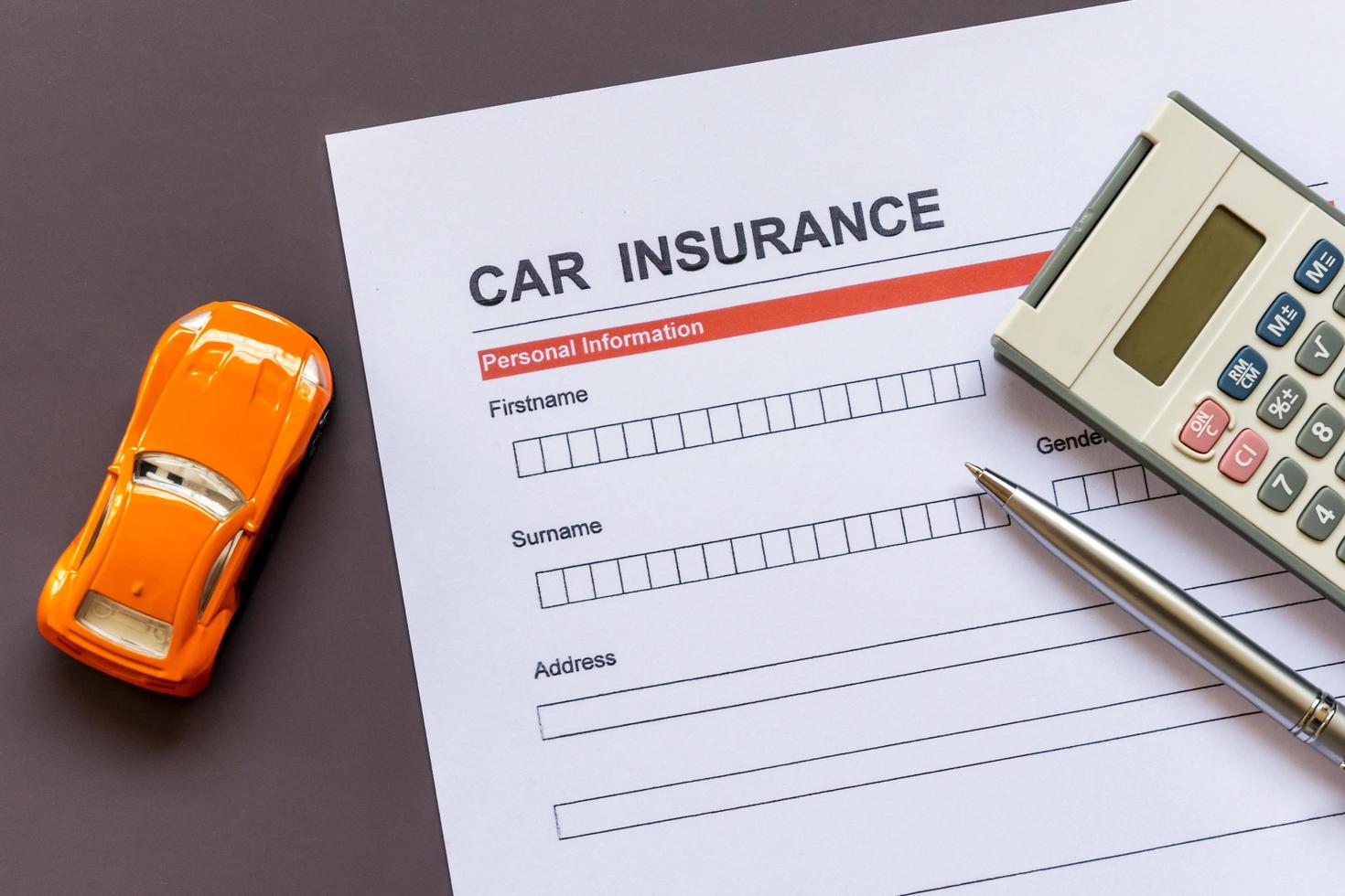 Car insurance form with model and policy document photo