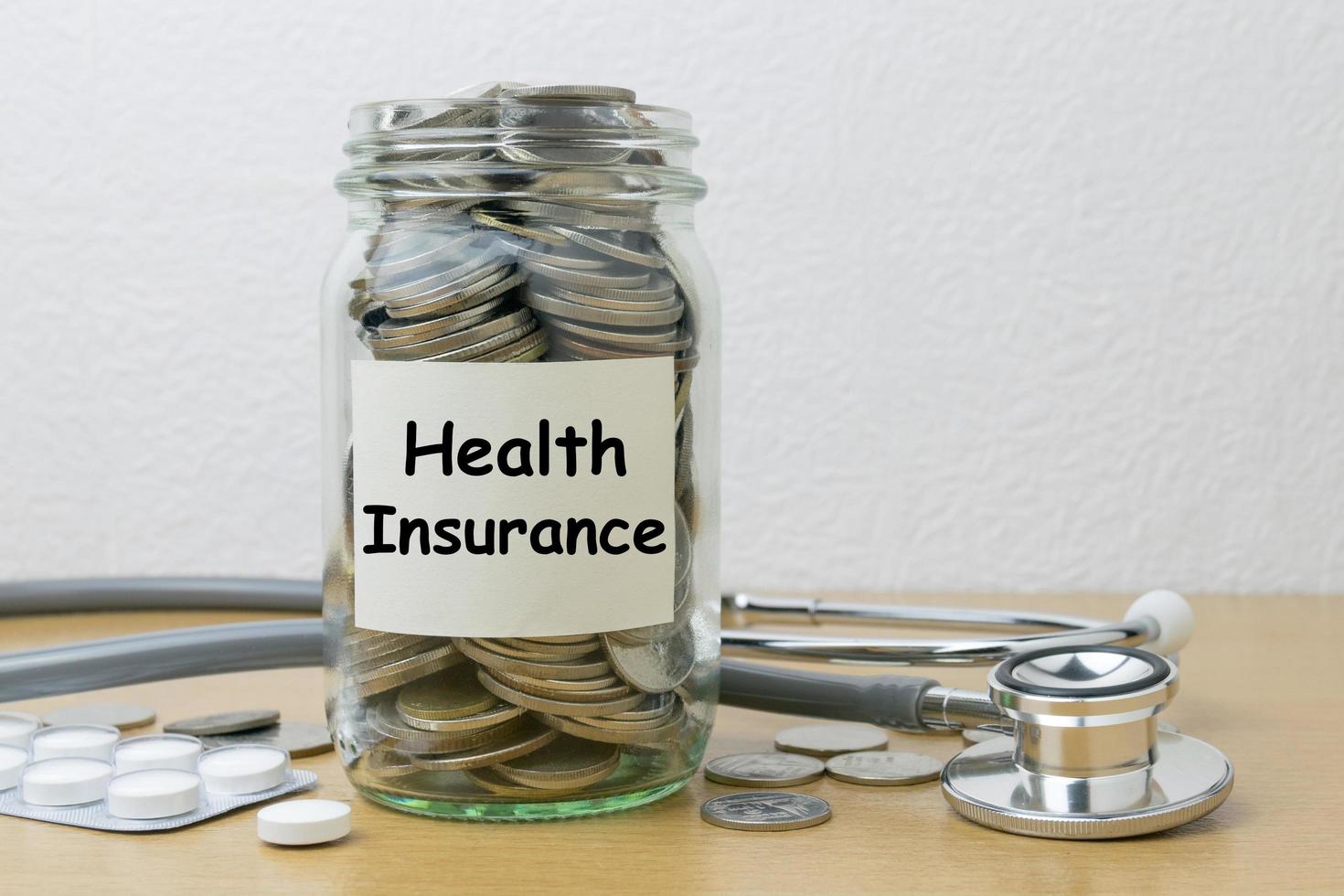 Money saving for health Insurance in the glass bottle photo
