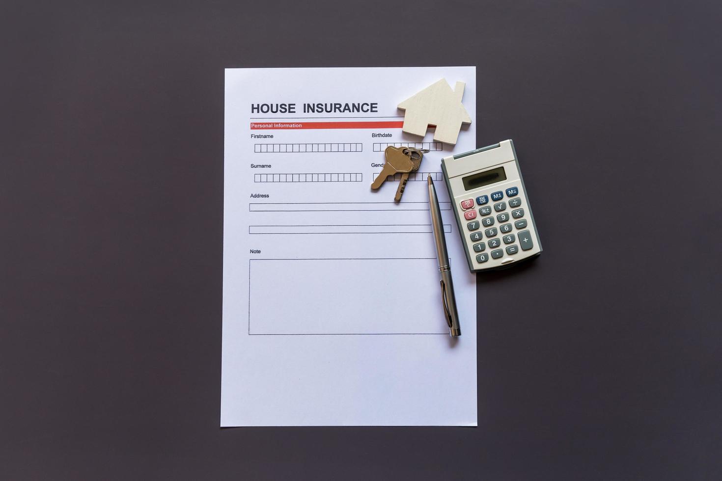 House insurance form with model and policy document photo