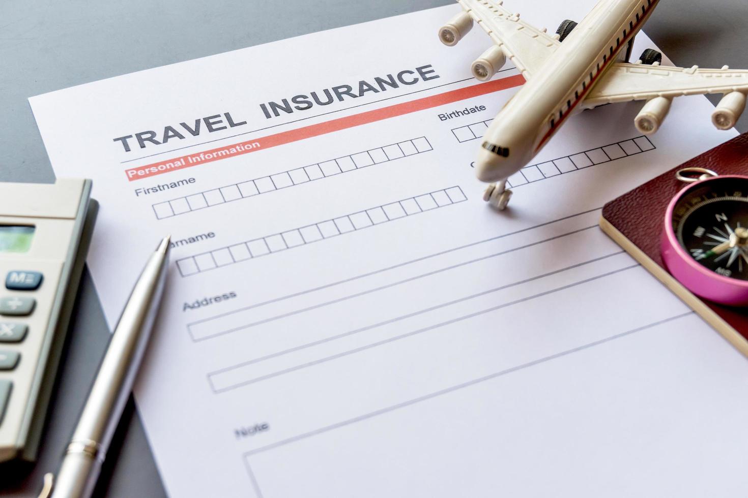 Travel  insurance form with model and policy document photo