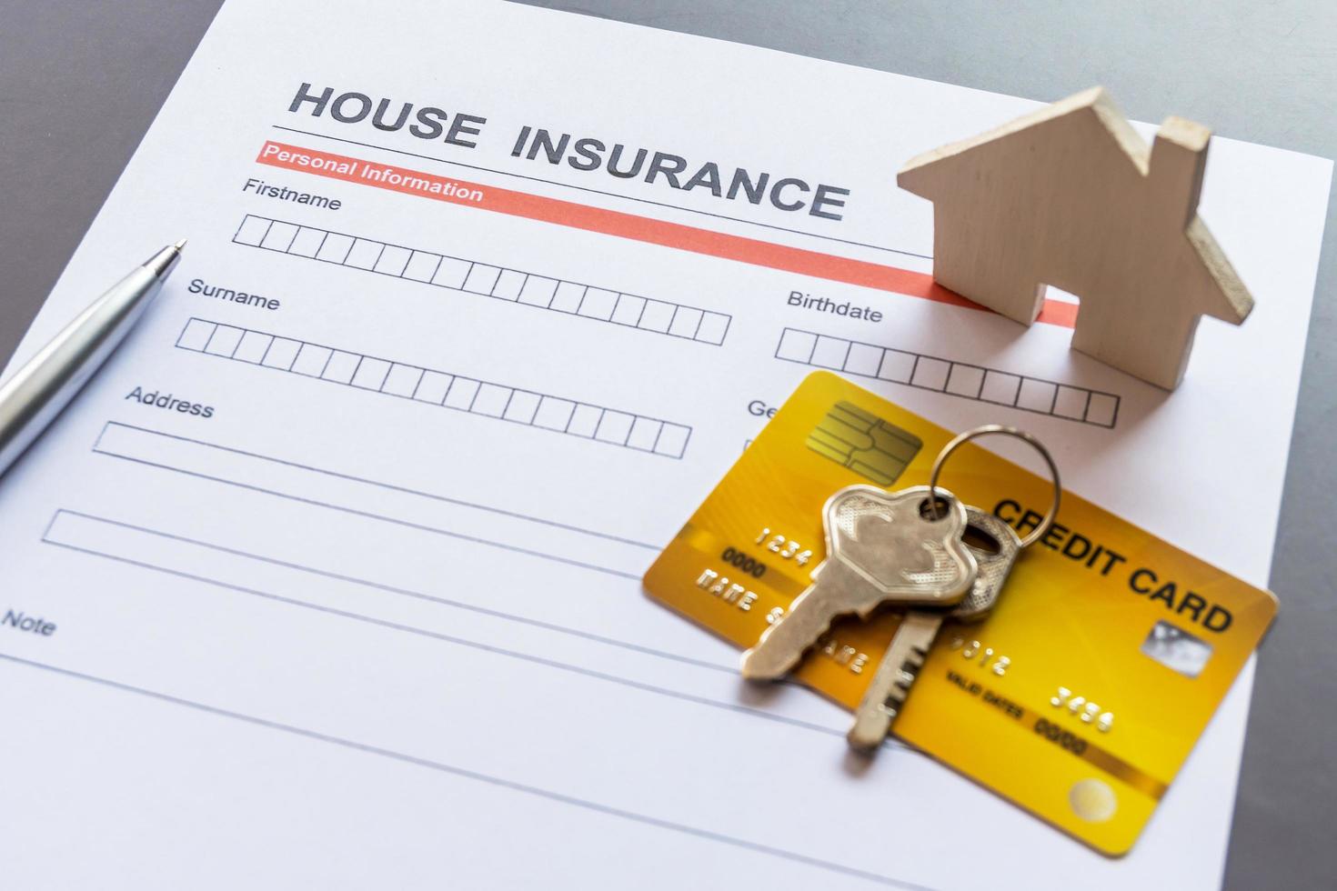 House insurance form with model and policy document photo