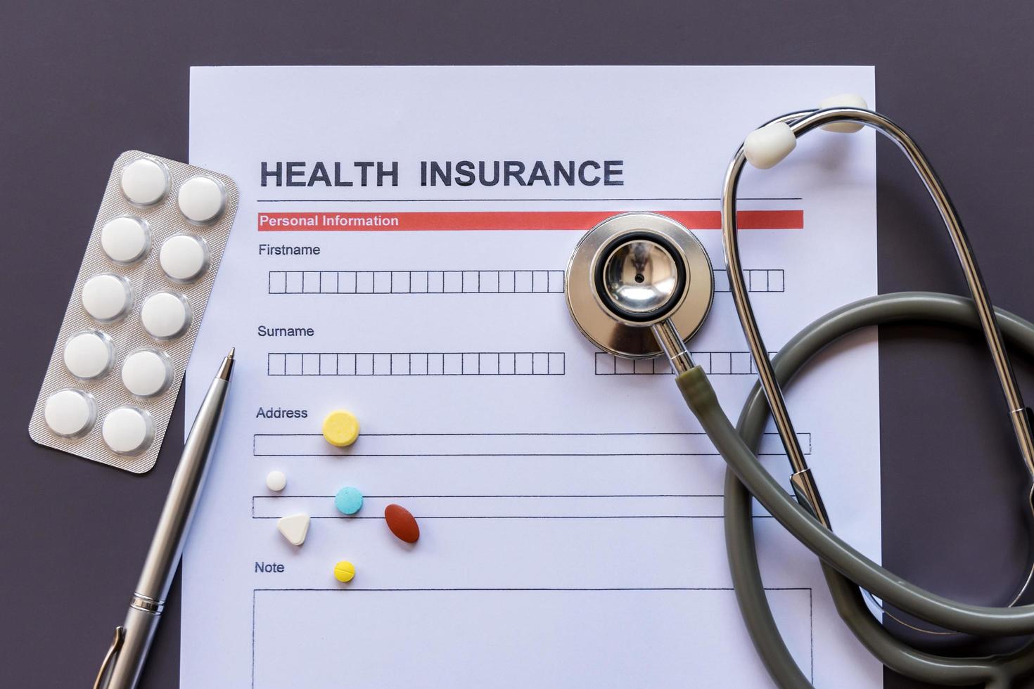 Health insurance form with model and policy document photo