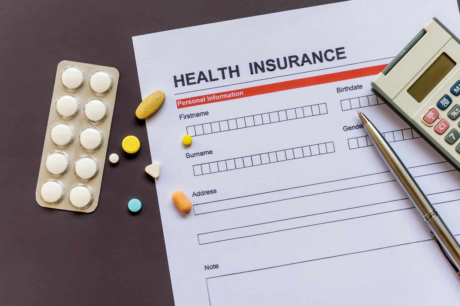 Health insurance form with model and policy document photo