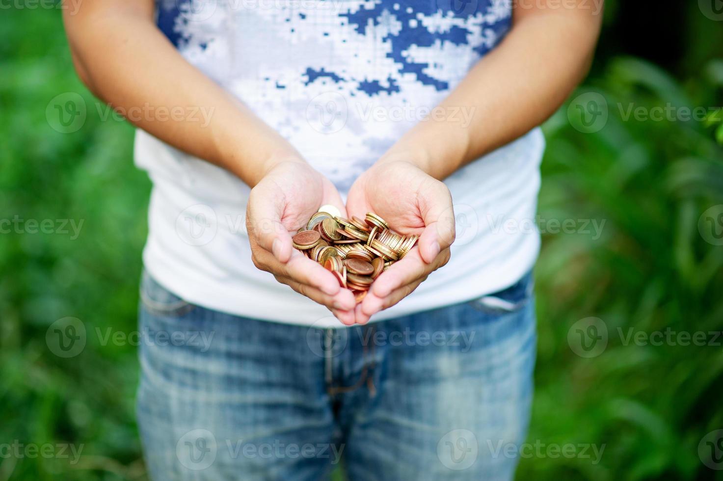 Hand and silver coin, concept of saving money for business operation, stable money in the future photo