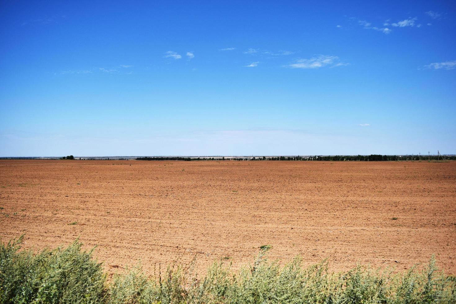 plowed field before sowing in sunny weather photo