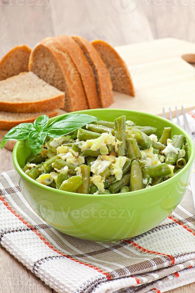String beans with eggs in bowl. photo