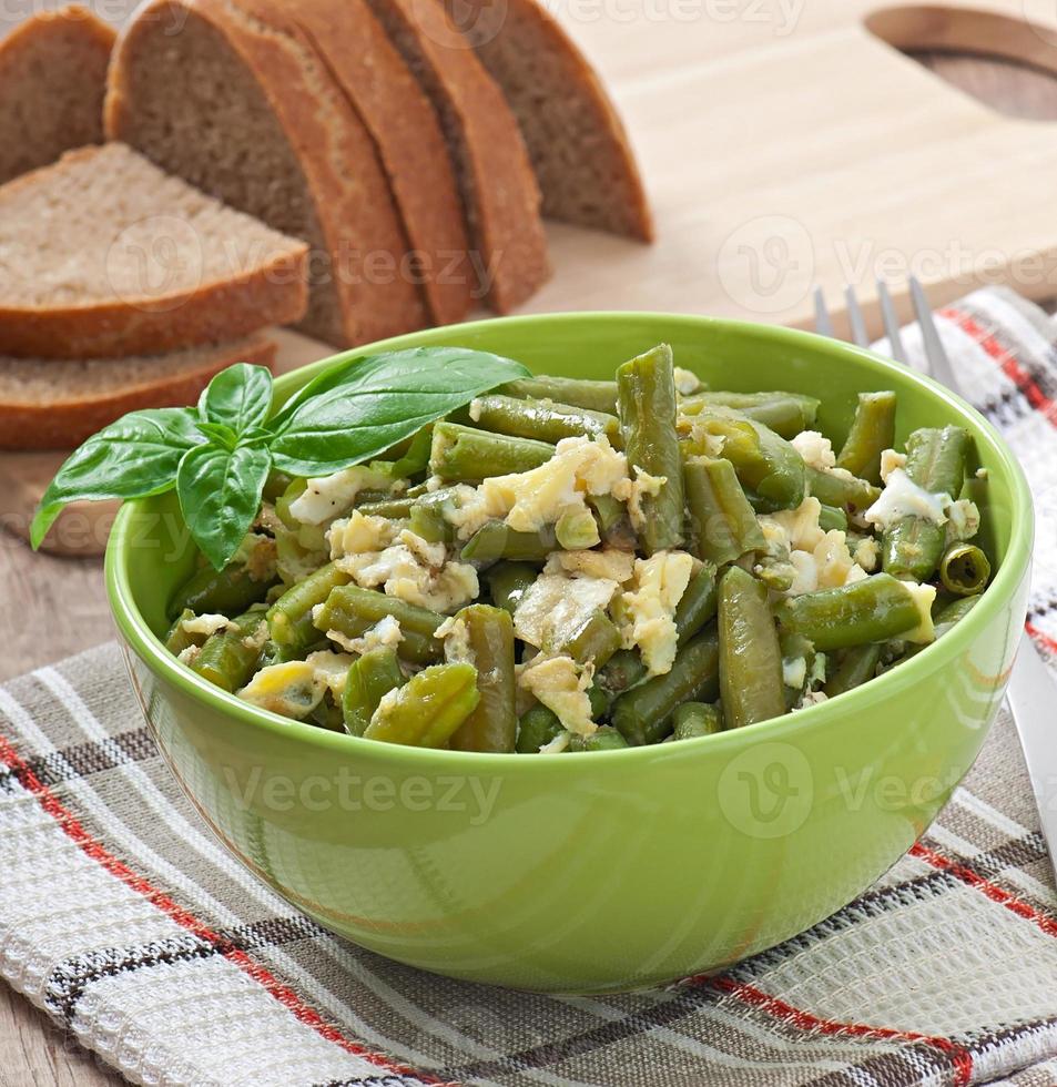 String beans with eggs in bowl. photo