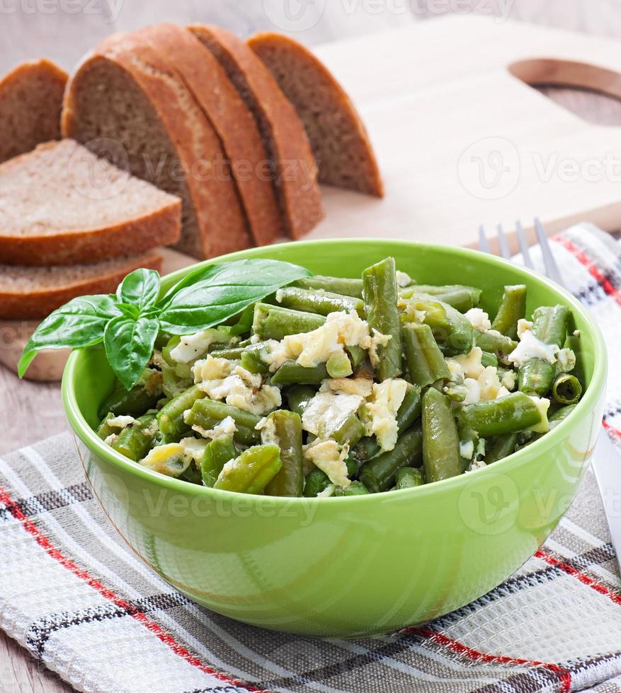 String beans with eggs in bowl. photo