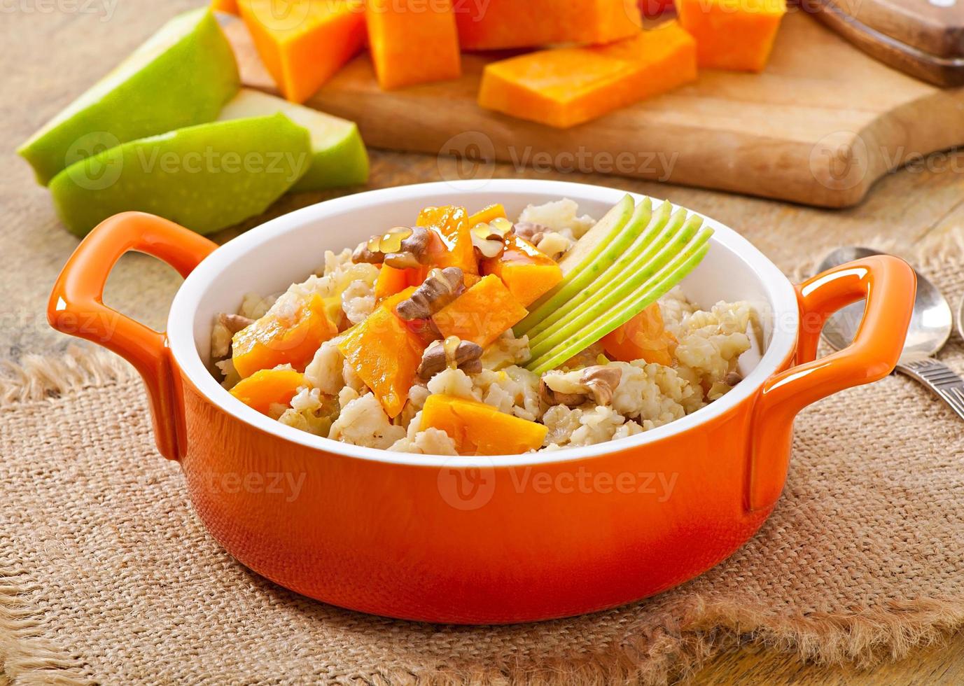 Oatmeal with pumpkin, apples, nuts and honey photo