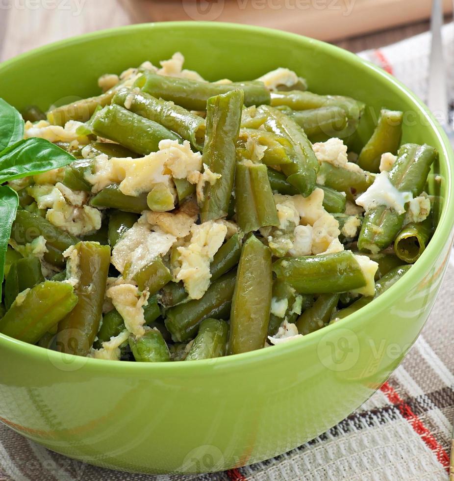 String beans with eggs in bowl. photo