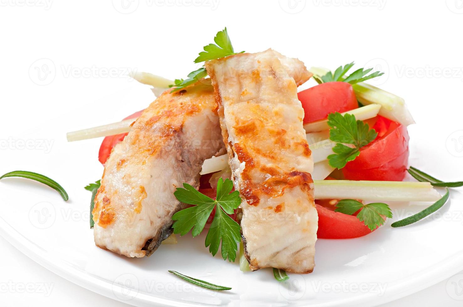 Fried filet fish and fresh vegetable salad photo