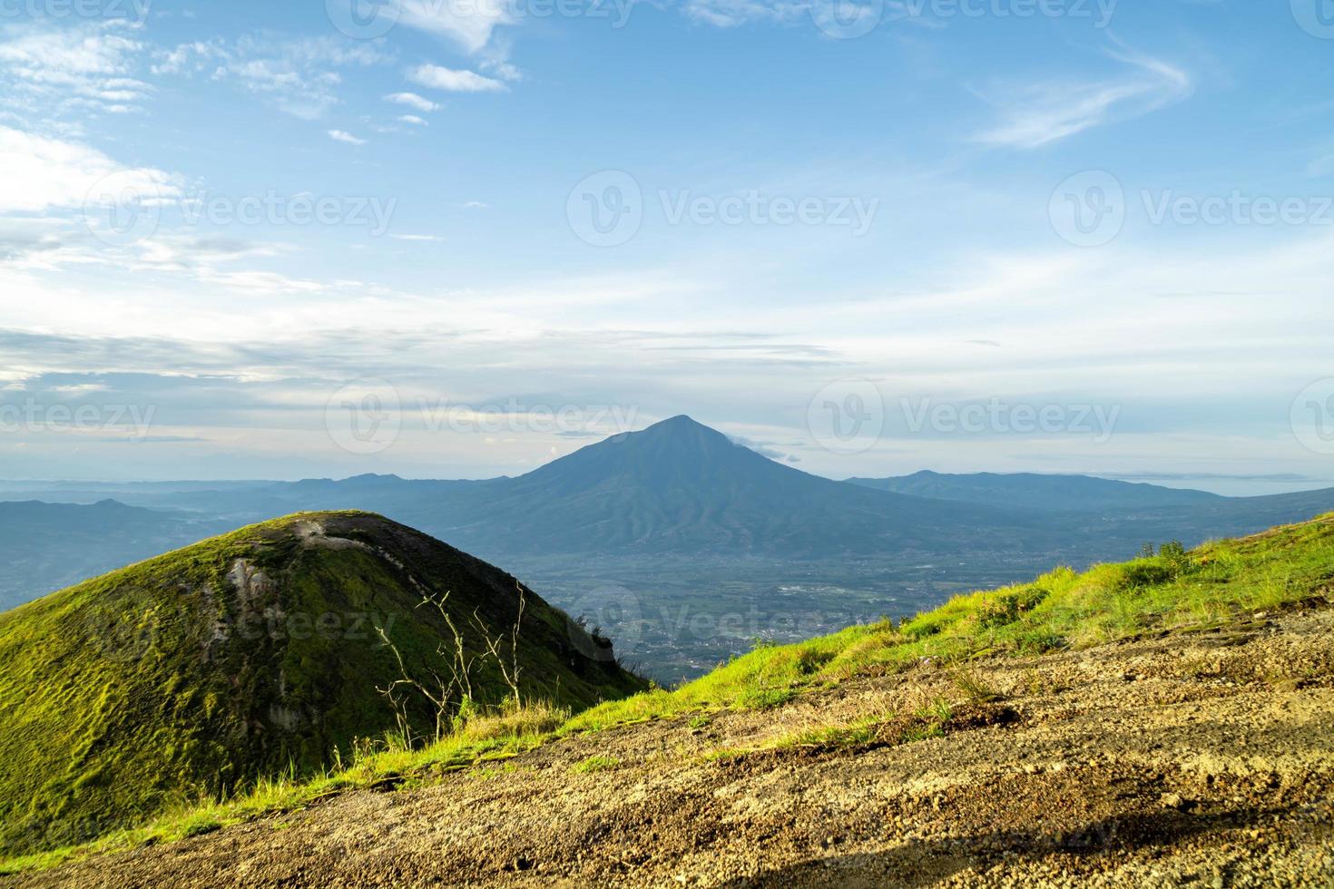 View of Indonesia's mountains with wide green grass photo