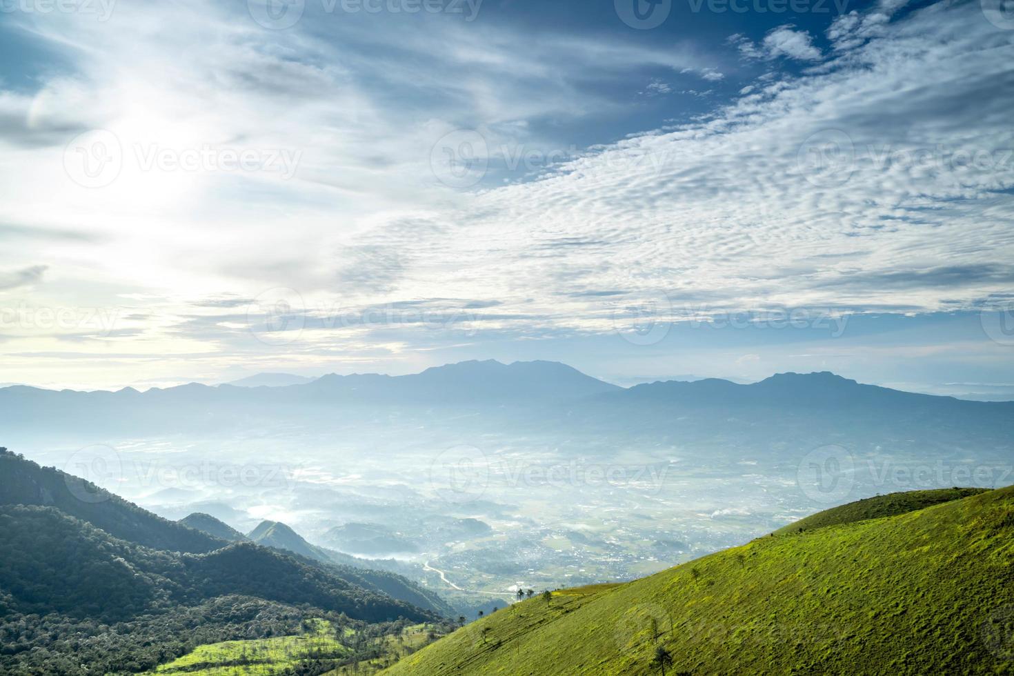 View of Indonesia's mountains with wide green grass photo