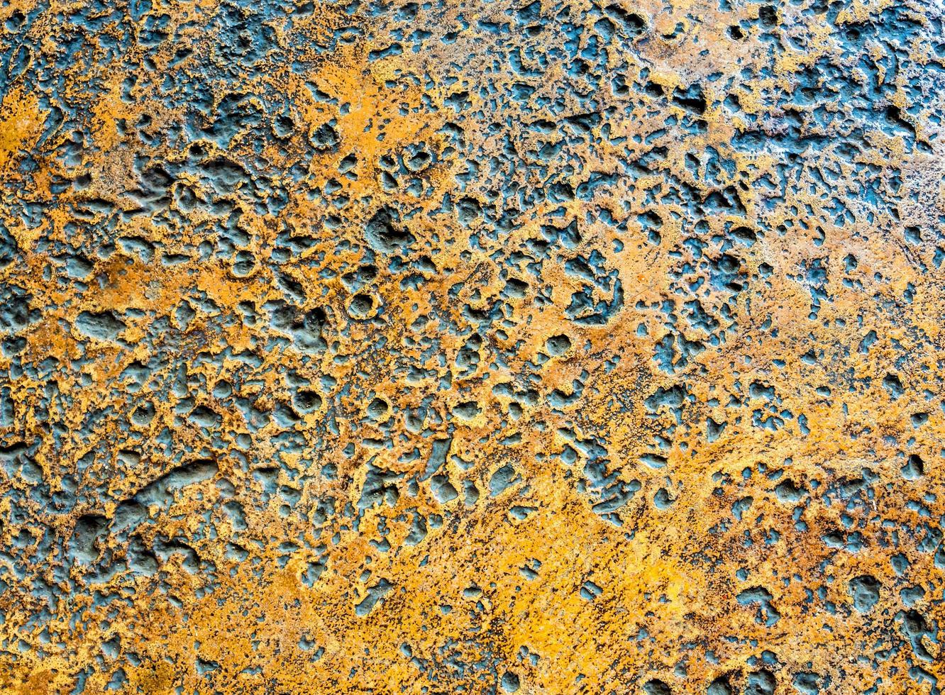 Many rugged holes on the rusty color concrete floor photo