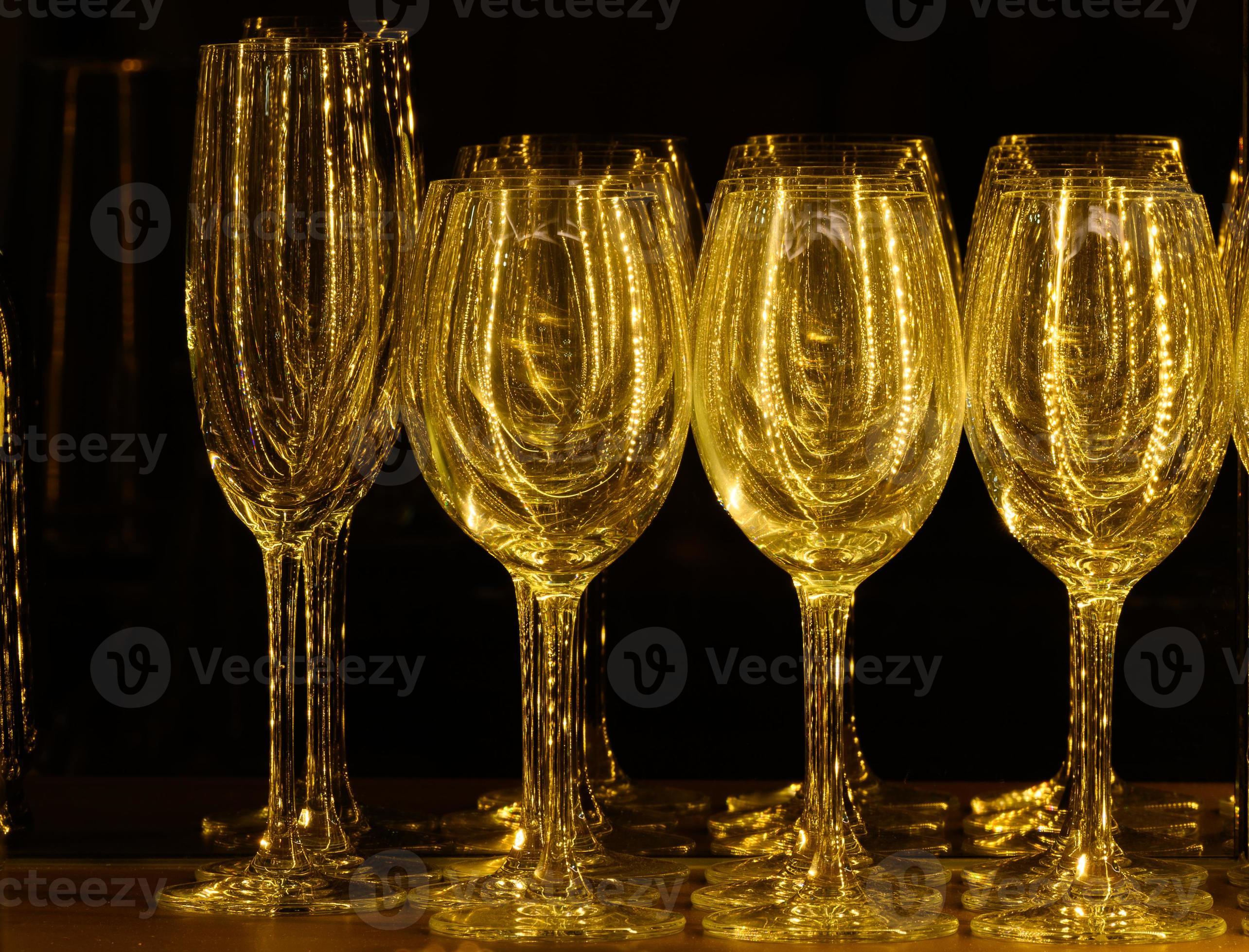 Set of glasses for different alcoholic drinks and cocktails on wood
