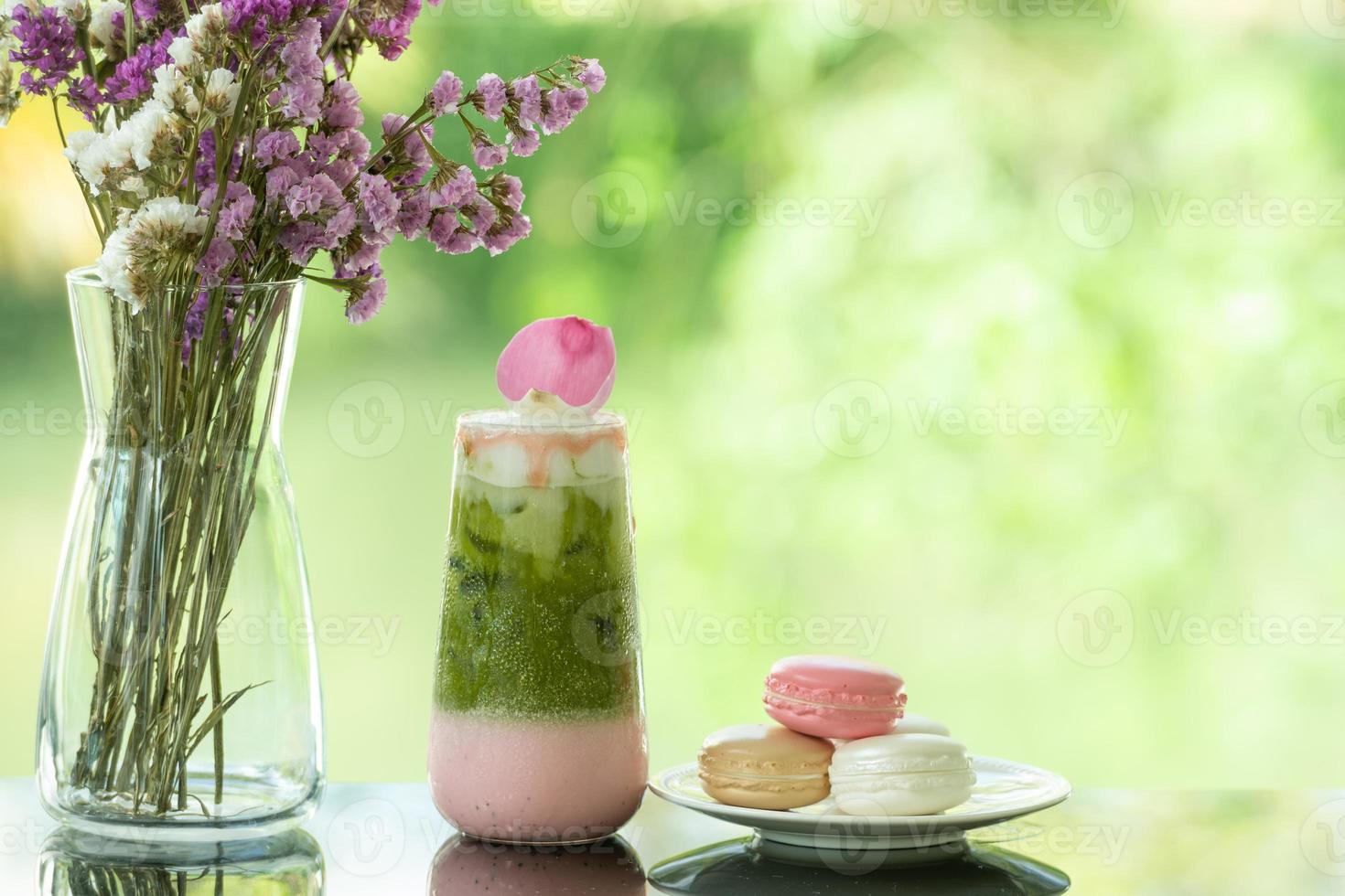 Close up of delicious juicy fresh milk green tea  on glass table Blurred leaf reflection background photo