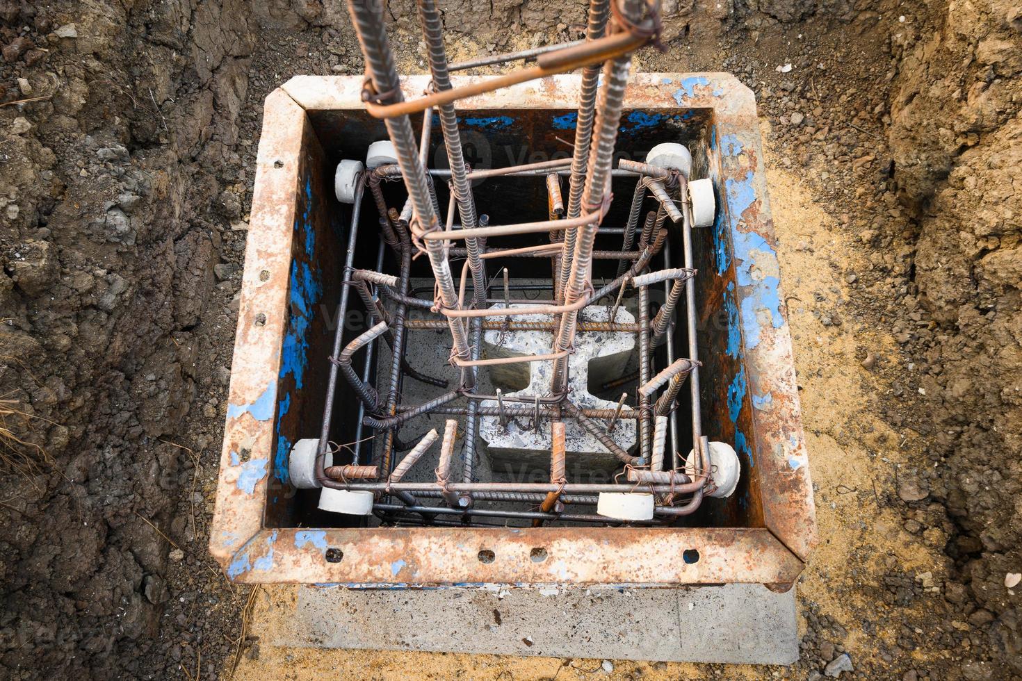 Construction of reinforced concrete foundation with piles to support building weight photo