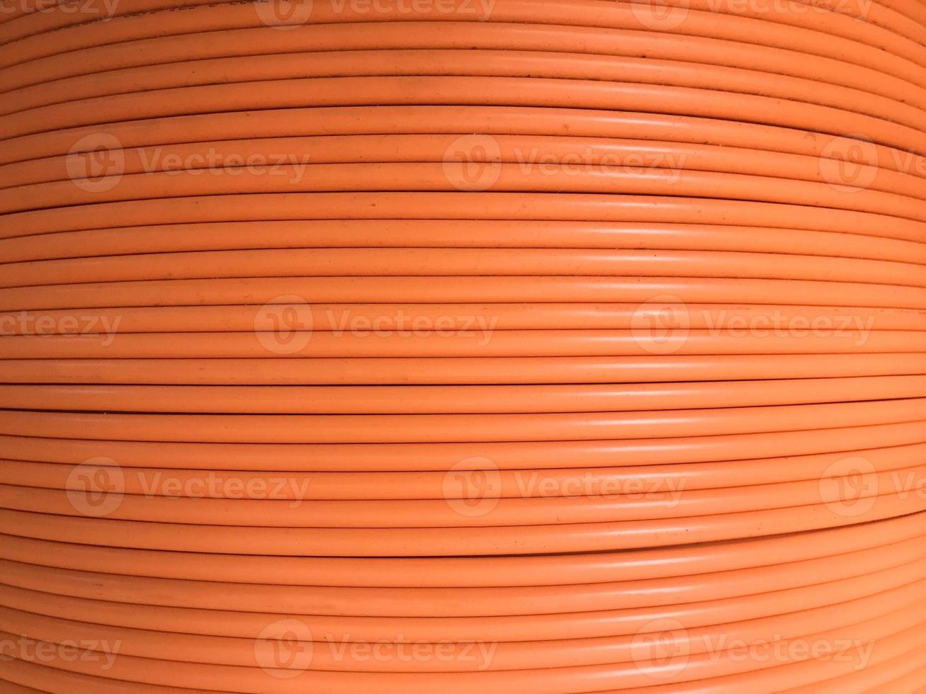 Fiber optic cables are arranged in rolls, Orange background with Fiber optic cables photo