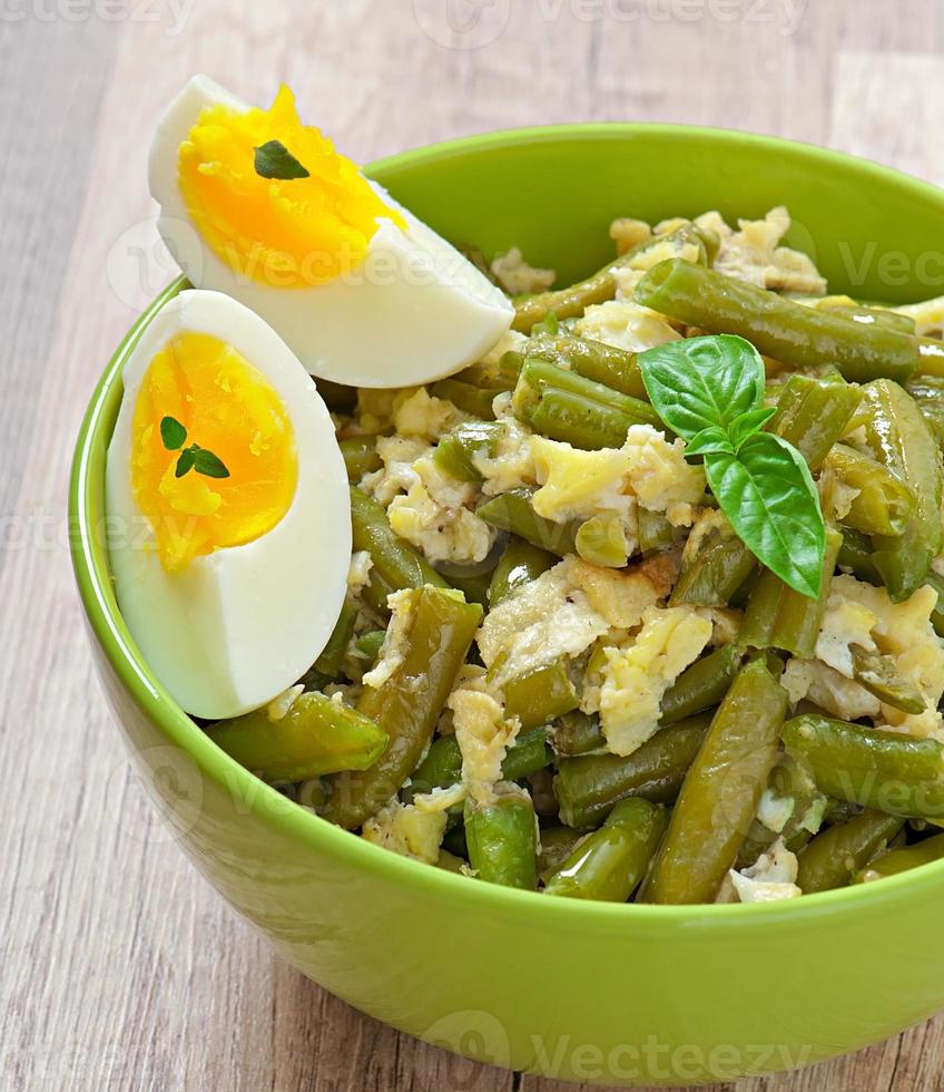 String beans with eggs in bowl. photo